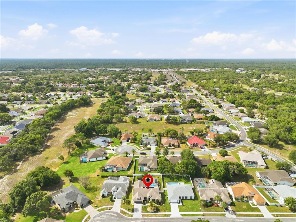 1049 Larkin Road Spring Hill, FL 34608 - Photo 62 of 64 an aerial view of residential houses with outdoor space and trees