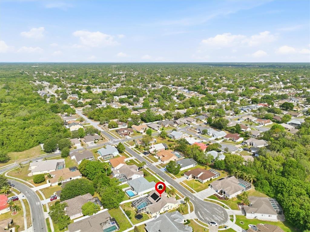 1049 Larkin Road Spring Hill, FL 34608 - Photo 63 of 64 an aerial view of residential houses with outdoor space