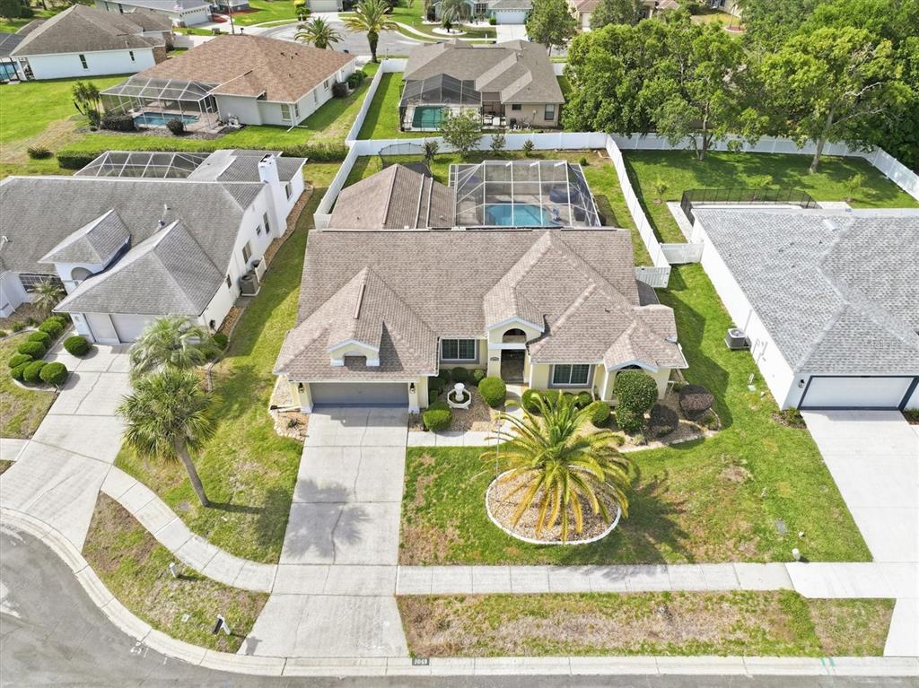 1049 Larkin Road Spring Hill, FL 34608 - Photo 7 of 64 an aerial view of a house with a garden and trees