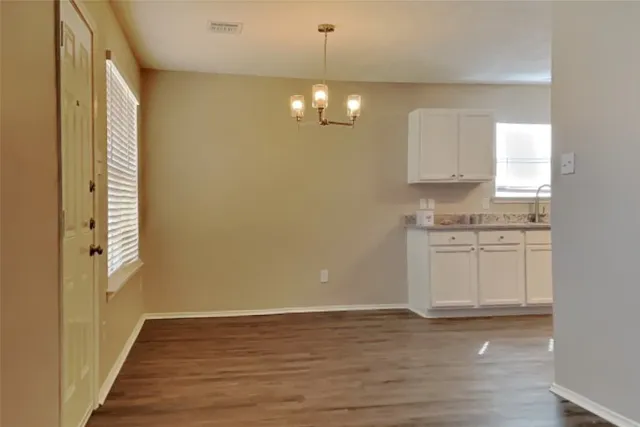 a view of a kitchen with wooden floor