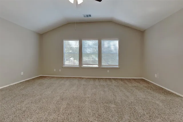 an empty room with a empty space and windows