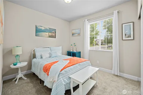 a bedroom with bed and a window