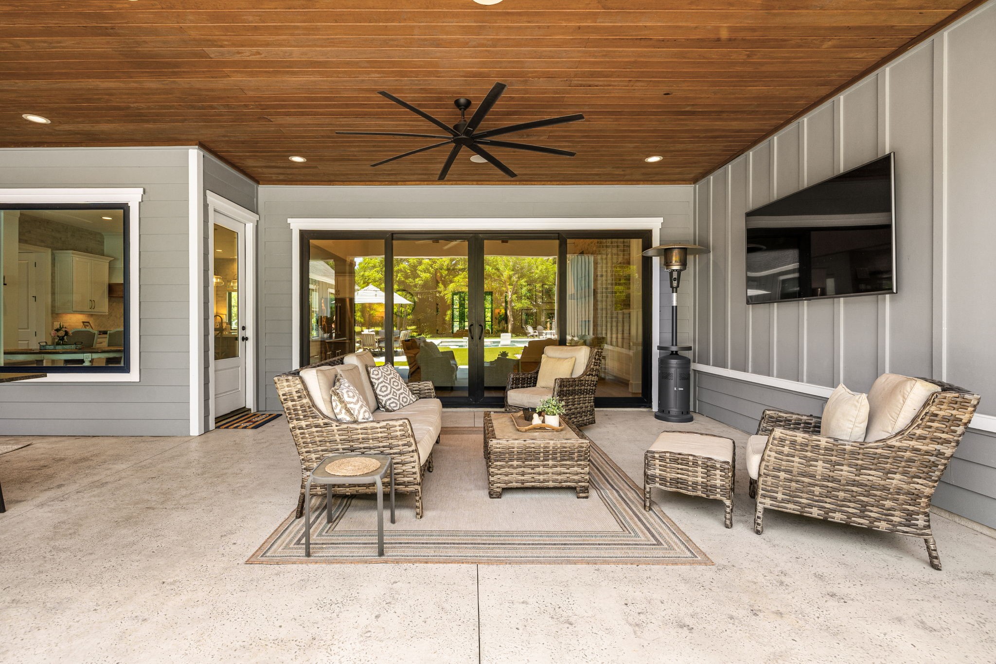 4311 Upper Oxbow Trace Fulshear, TX 77441 - Photo 38 of 49 Spacious outdoor lounge area with oversized sliding doors creating the perfect indoor-outdoor flow for entertaining guests year-round.