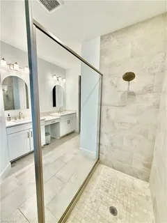 a spacious bathroom with a double vanity sink and a mirror