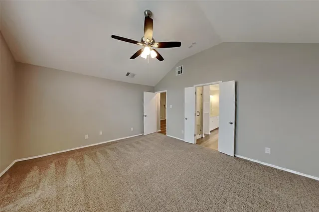 an empty room with closet and windows