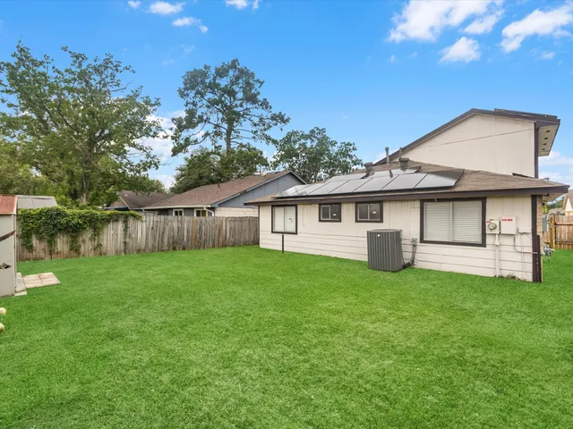 a view of a house with a yard and sitting area