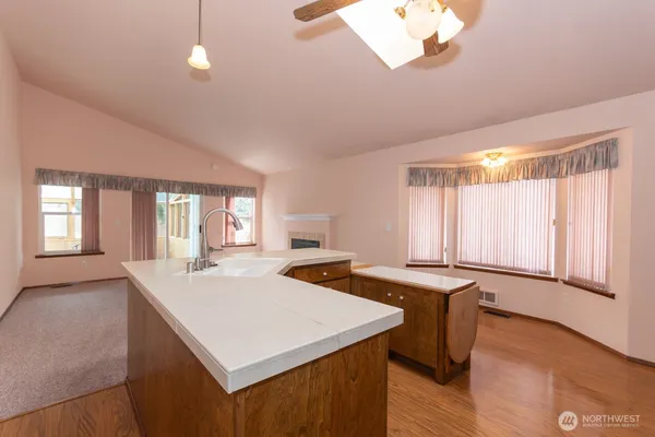 a open kitchen with stainless steel appliances granite countertop a granite counter tops and a window