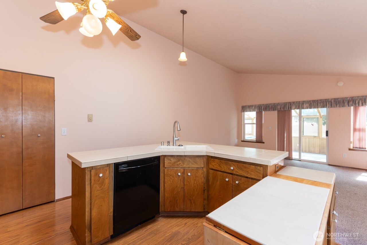 861 East Spruce Street Sequim, WA 98382 - Photo 15 of 39 a kitchen with a sink and a refrigerator