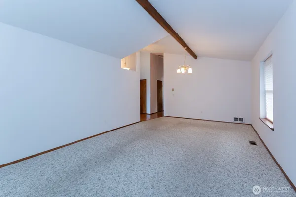 a view of a big room with closet and windows