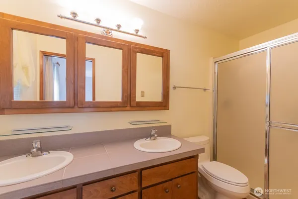 a bathroom with a sink a toilet and mirror