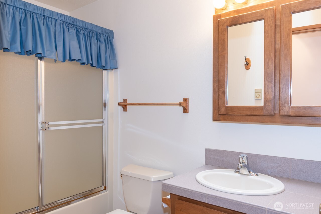 861 East Spruce Street Sequim, WA 98382 - Photo 19 of 39 a bathroom with a sink a light fixture and a toilet