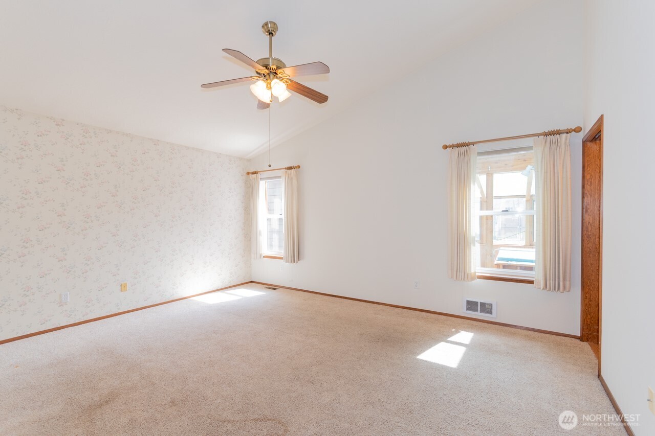 861 East Spruce Street Sequim, WA 98382 - Photo 20 of 39 an empty room with windows and fan