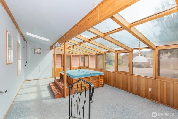 a view of a porch with furniture and backyard