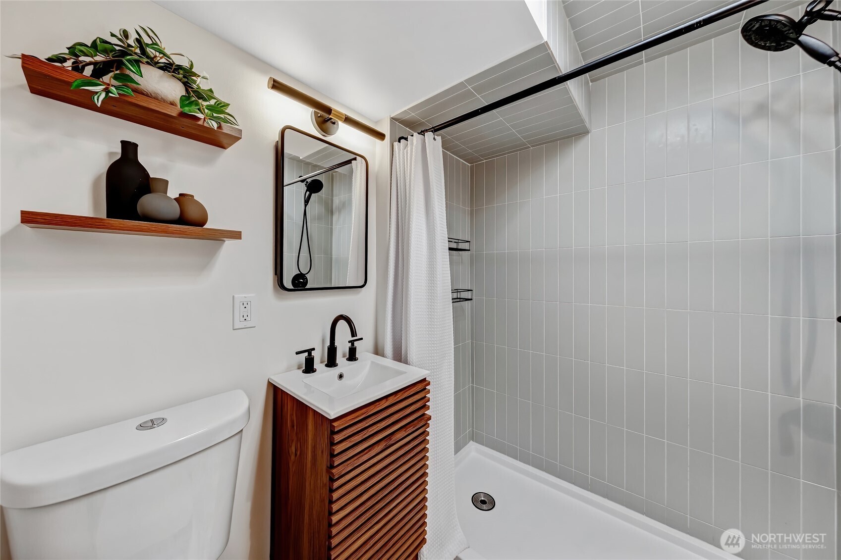 7571 45th Avenue Southwest Seattle, WA 98136 - Photo 35 of 40 a bathroom with a sink a mirror and shower