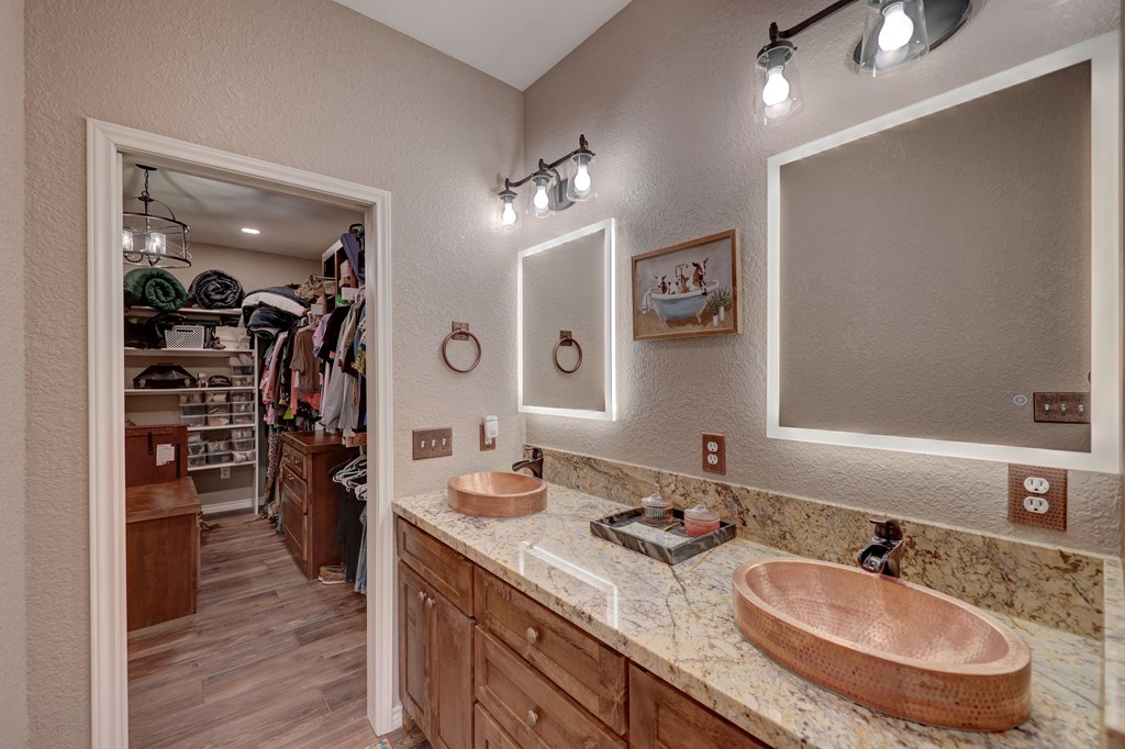 8177 Wendel Road Harper, TX 78631 - Photo 12 of 32 a bathroom with a granite countertop sink a toilet and a mirror