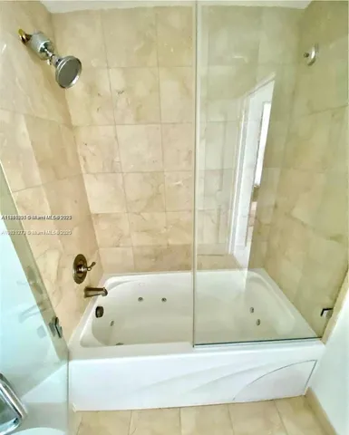 a bathroom with a bathtub and shower