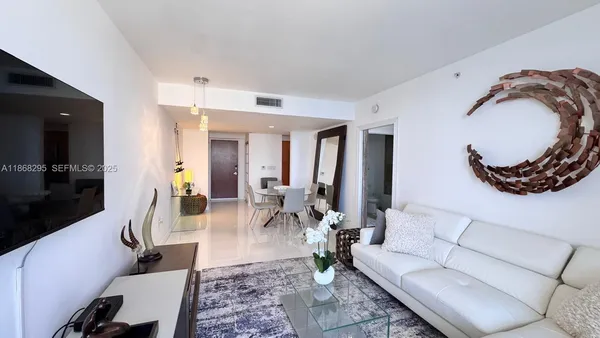 a living room with furniture and a mirror