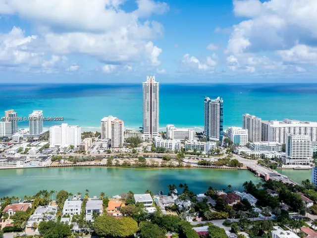 a front view of a city with lots of trees and houses