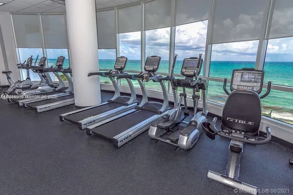 a room with gym equipment and a large window