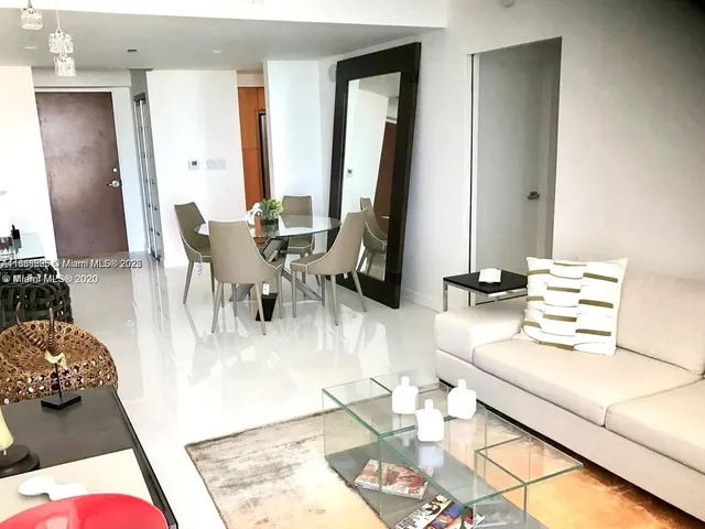 a living room with furniture and a large mirror