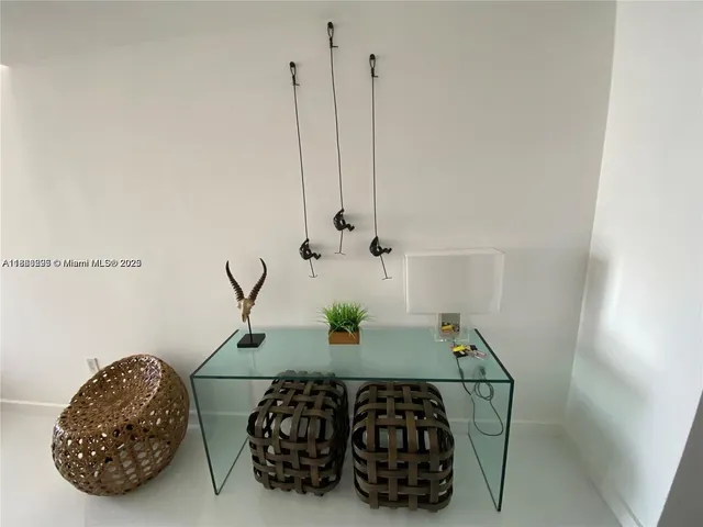 a table with wine bottles and chairs in it