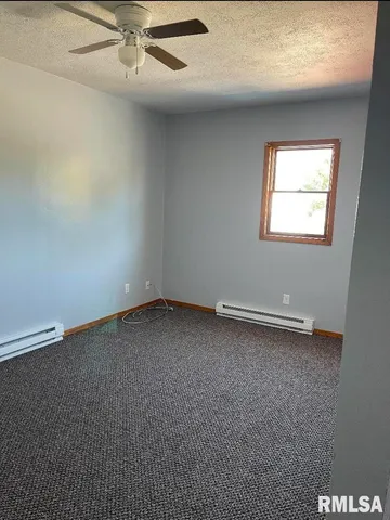 a room with wooden cabinets washer and dryer