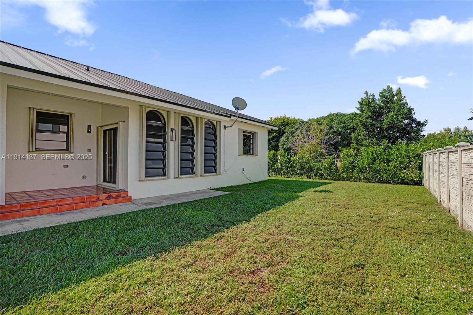 8371 Southwest 122nd Street Miami, FL 33156 - Photo 11 of 39 a front view of a house with a yard