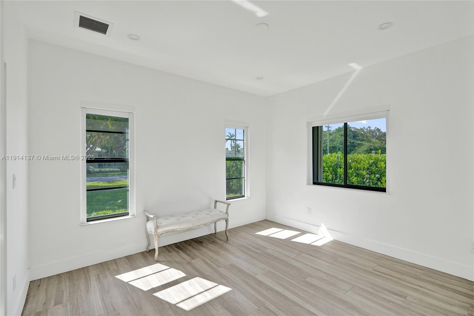 8371 Southwest 122nd Street Miami, FL 33156 - Photo 14 of 39 an empty room with wooden floor and windows