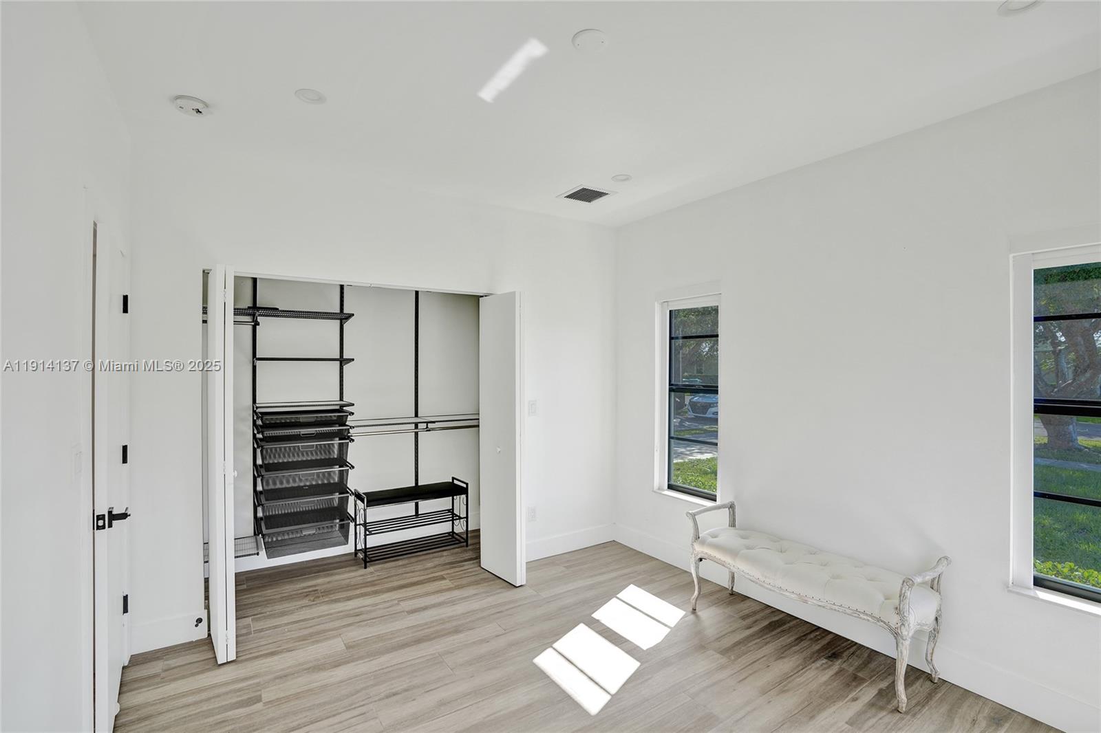 8371 Southwest 122nd Street Miami, FL 33156 - Photo 17 of 39 a view of an empty room with a window and wooden floor