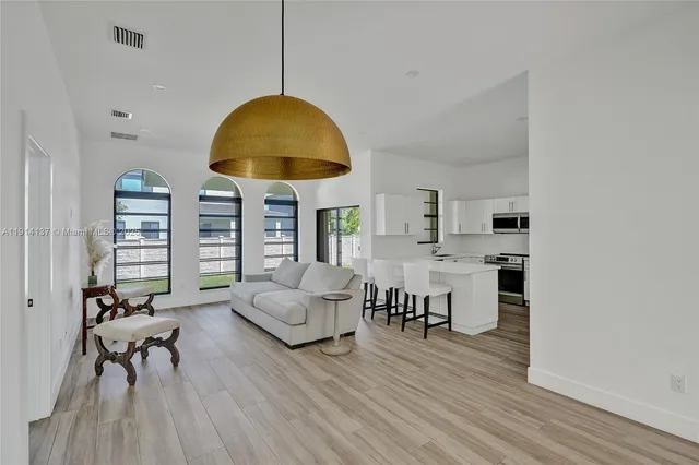 a living room with furniture and a chandelier