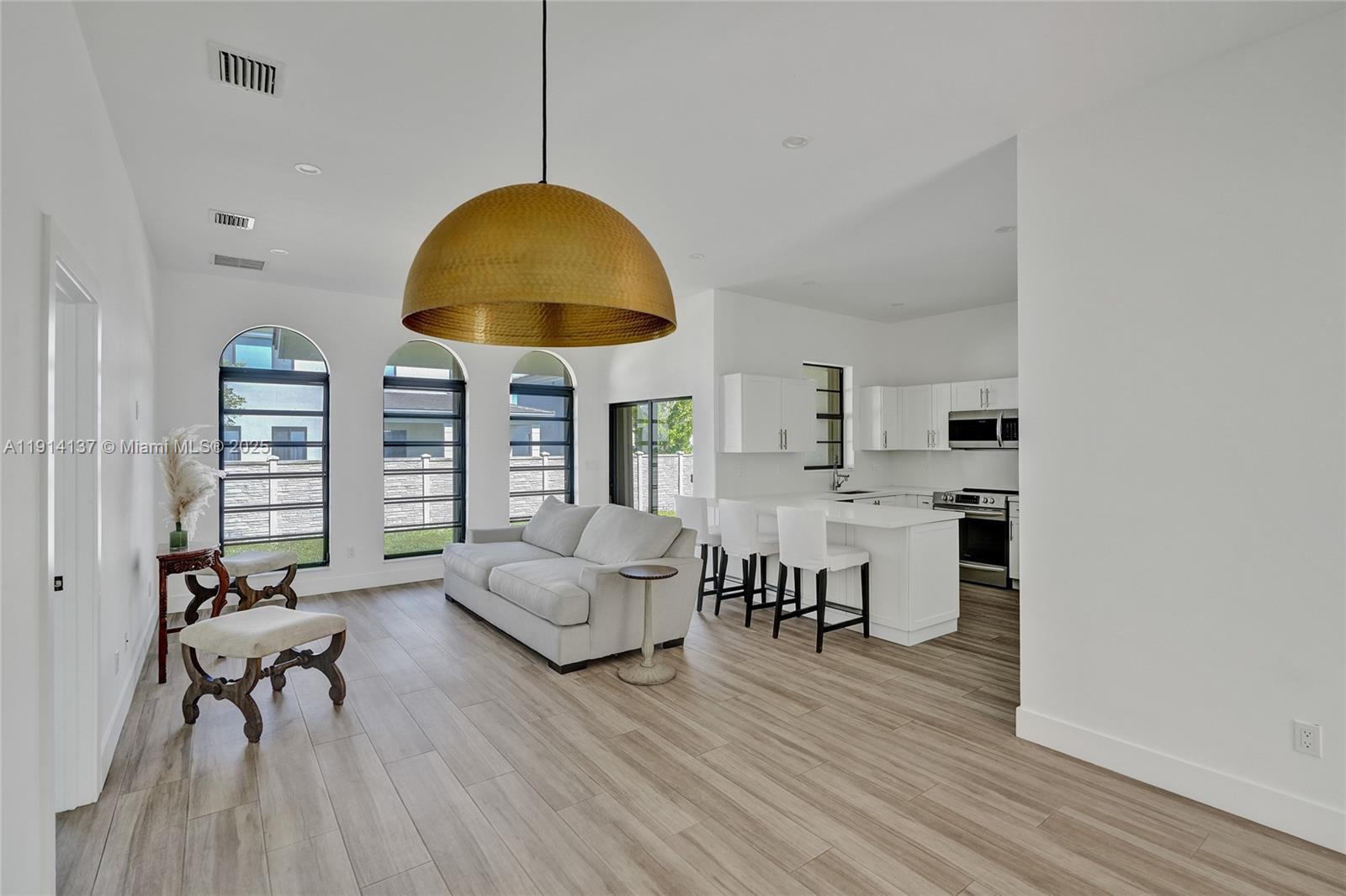 8371 Southwest 122nd Street Miami, FL 33156 - Photo 21 of 39 a living room with furniture and a chandelier