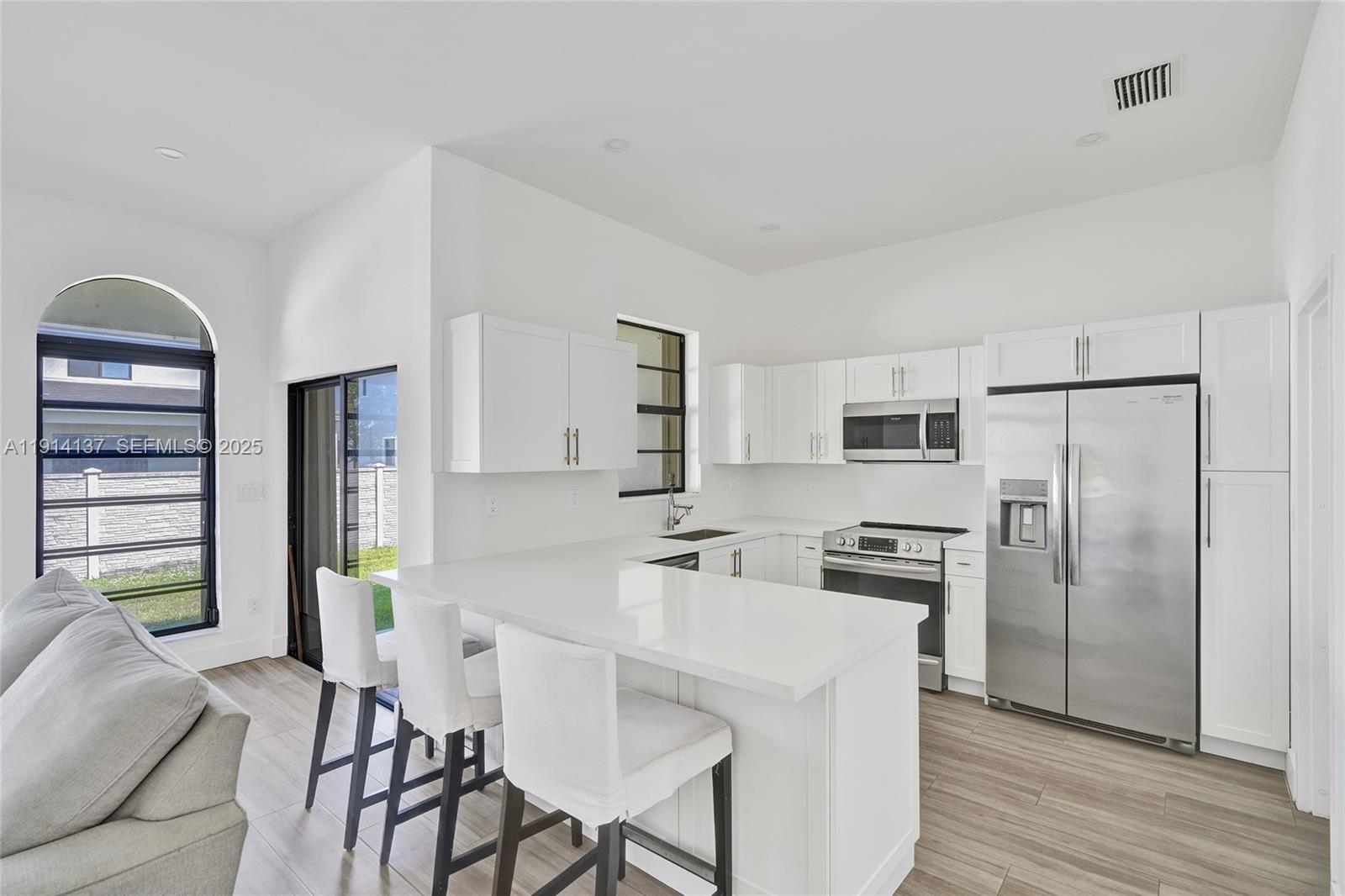 8371 Southwest 122nd Street Miami, FL 33156 - Photo 23 of 39 a kitchen with stainless steel appliances a refrigerator and a stove top oven