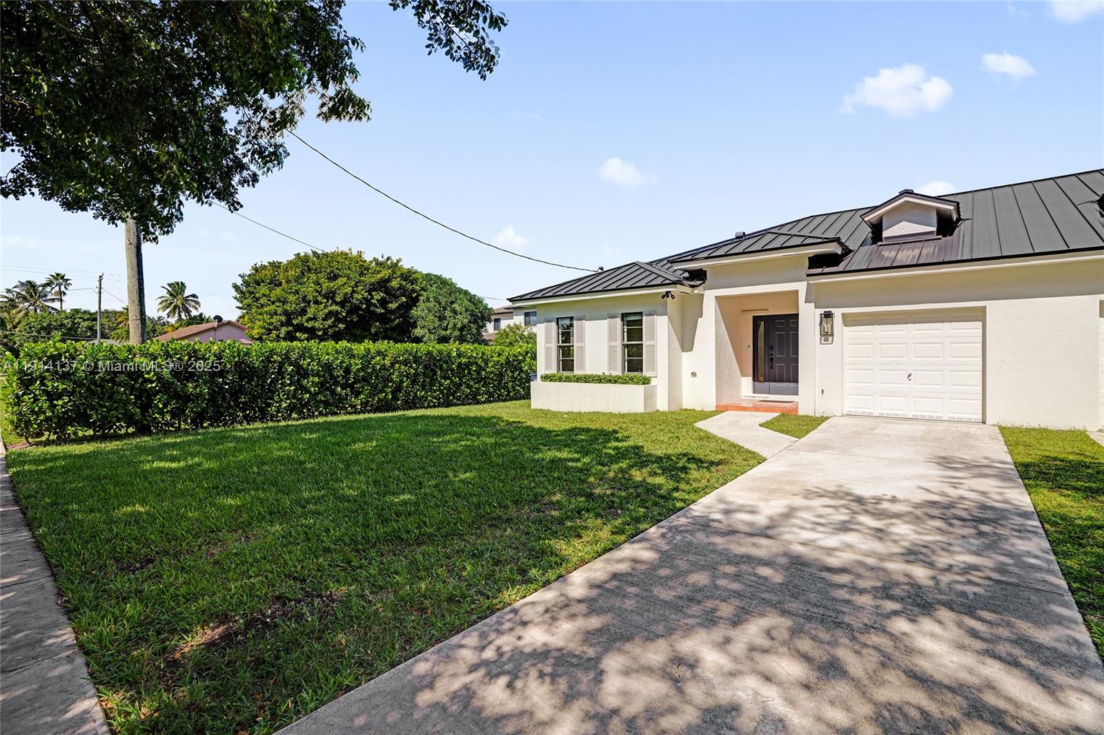8371 Southwest 122nd Street Miami, FL 33156 - Photo 3 of 39 a front view of a house with garden