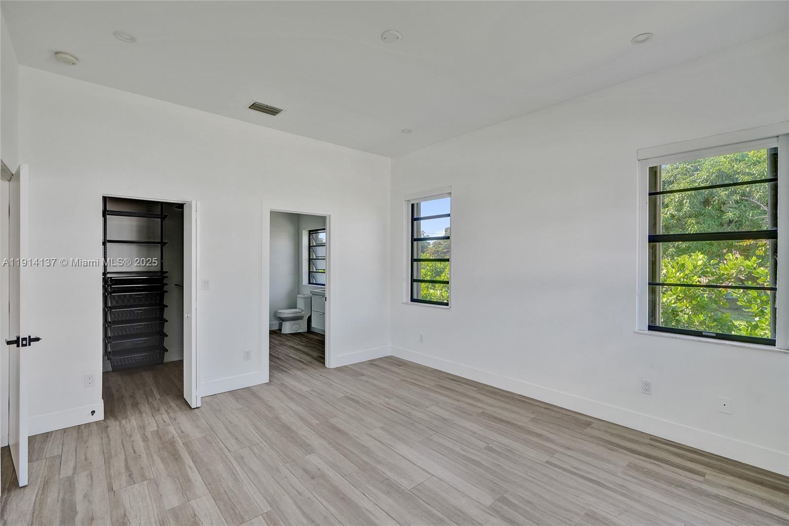 8371 Southwest 122nd Street Miami, FL 33156 - Photo 33 of 39 an empty room with windows and closet