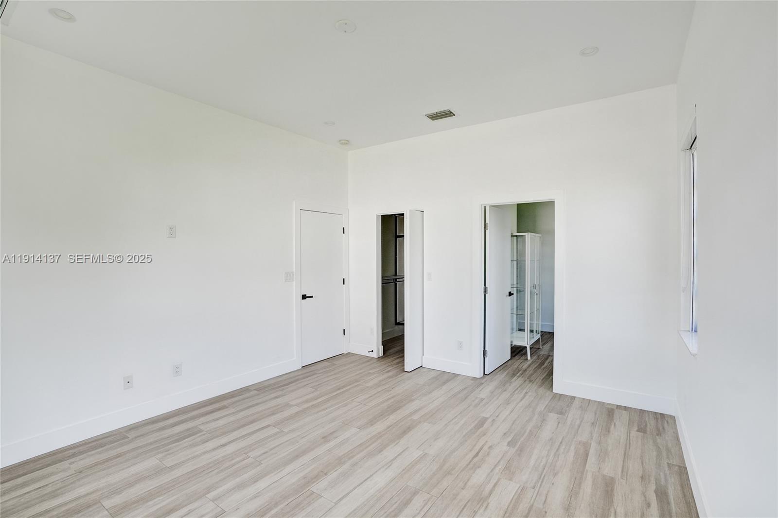 8371 Southwest 122nd Street Miami, FL 33156 - Photo 34 of 39 a view of a room with wooden floor and white doors