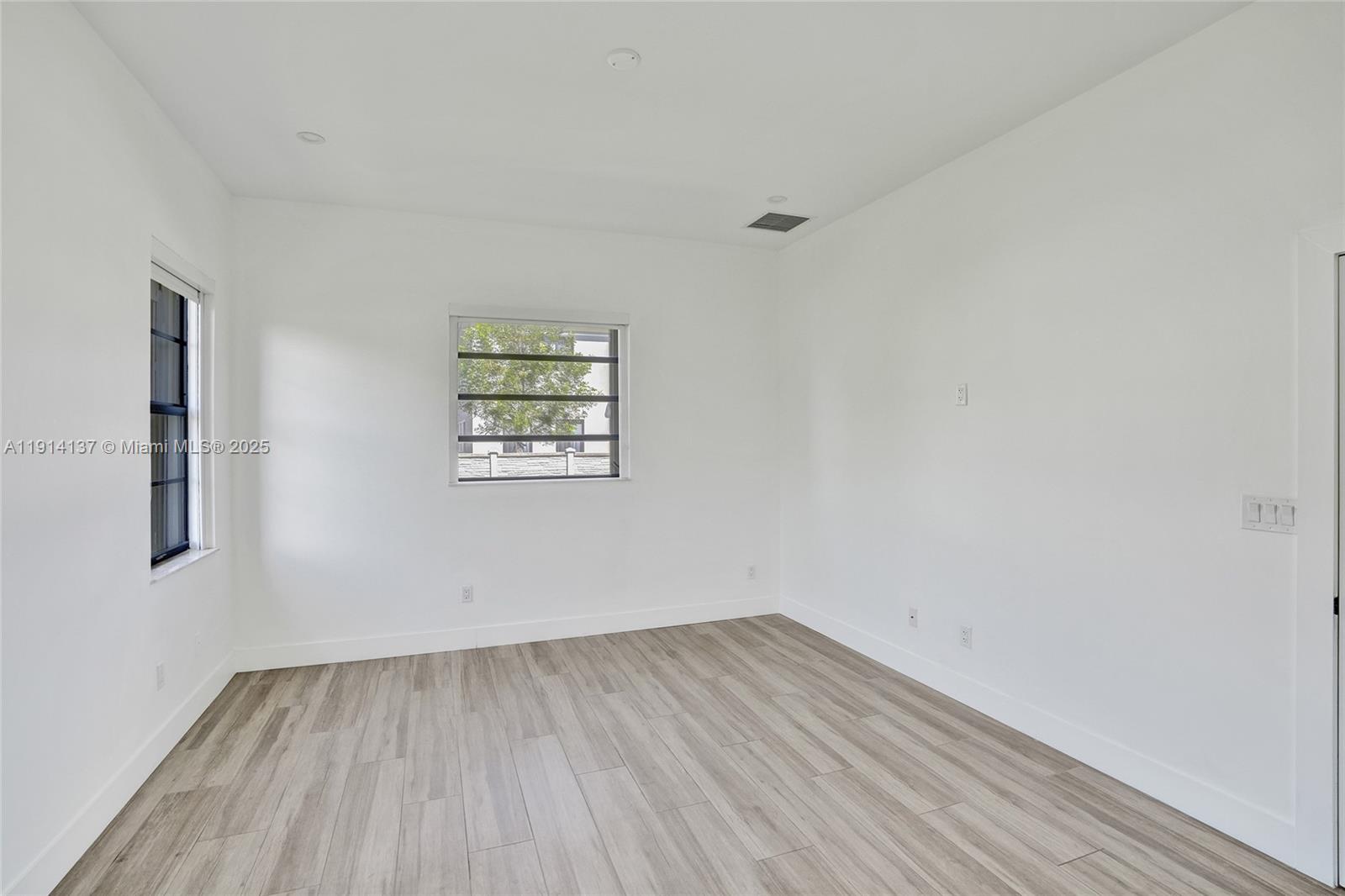 8371 Southwest 122nd Street Miami, FL 33156 - Photo 35 of 39 a view of a room with wooden floor and window