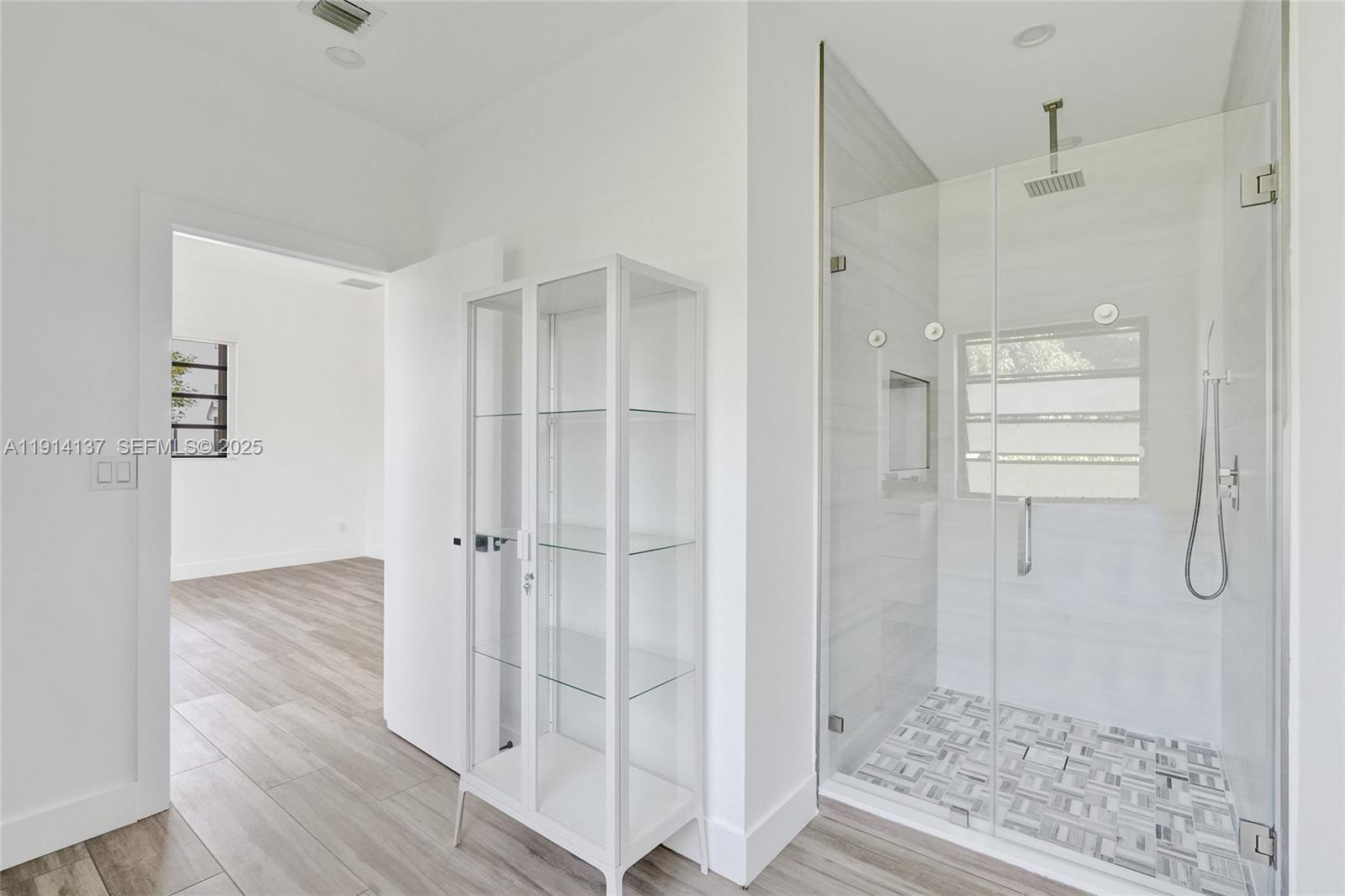 8371 Southwest 122nd Street Miami, FL 33156 - Photo 38 of 39 a bathroom with a glass shower door