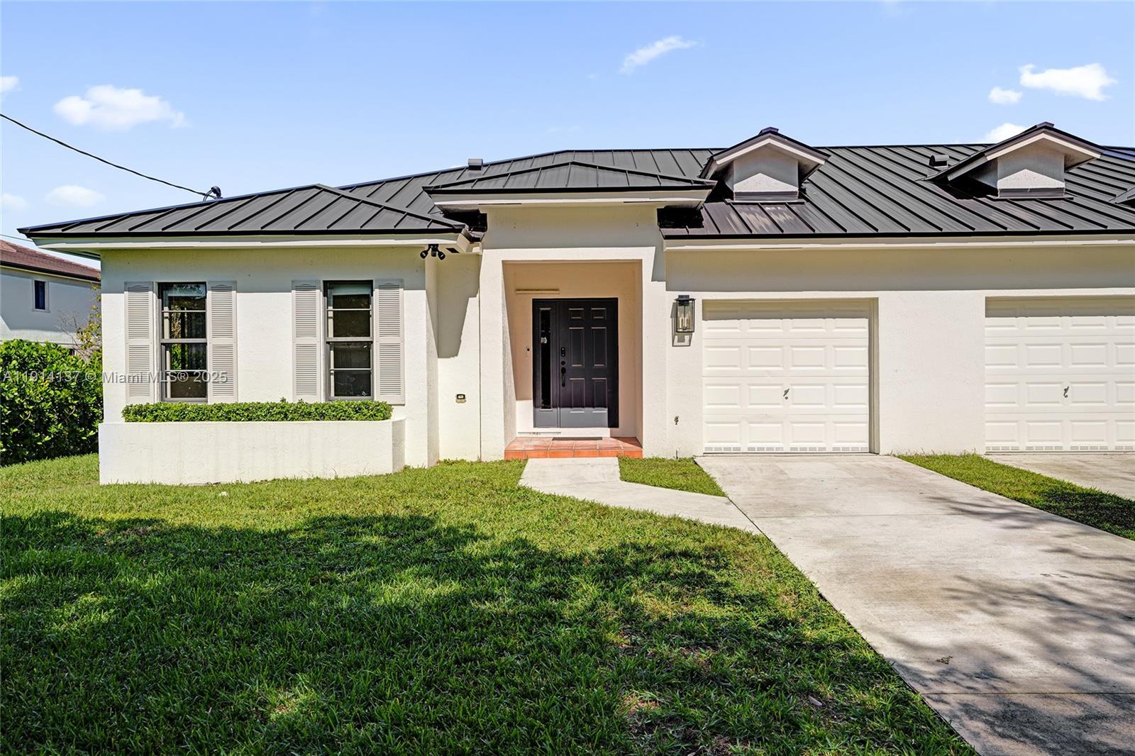 8371 Southwest 122nd Street Miami, FL 33156 - Photo 4 of 39 a front view of a house with a garden and plants