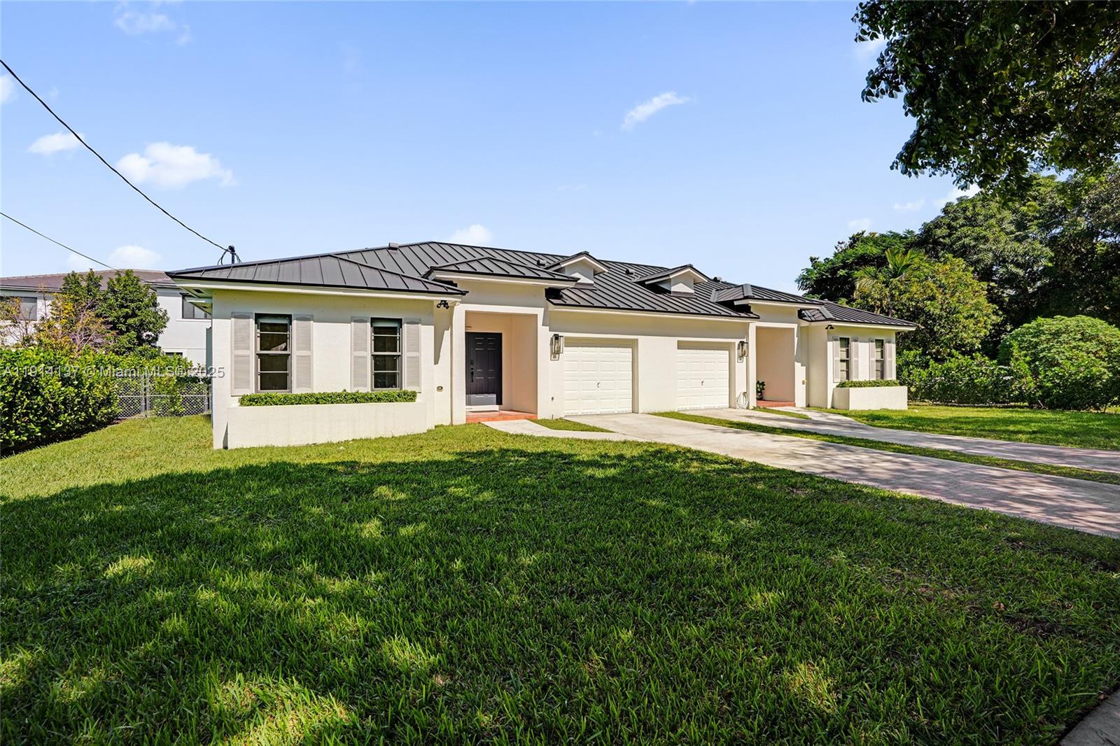 8371 Southwest 122nd Street Miami, FL 33156 - Photo 5 of 39 a front view of a house with a garden