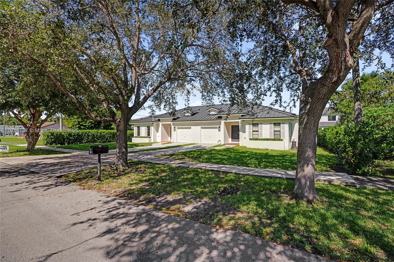 8371 Southwest 122nd Street Miami, FL 33156 - Photo 8 of 39 a house view with a garden space
