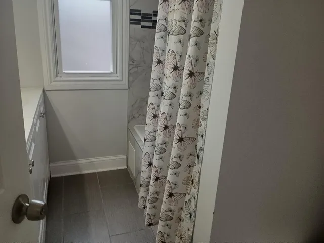 a bathroom with a shower curtain
