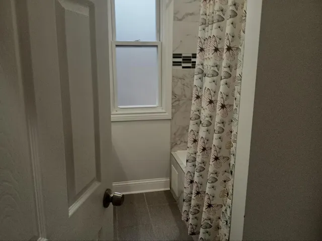 a bathroom with a shower and a sink