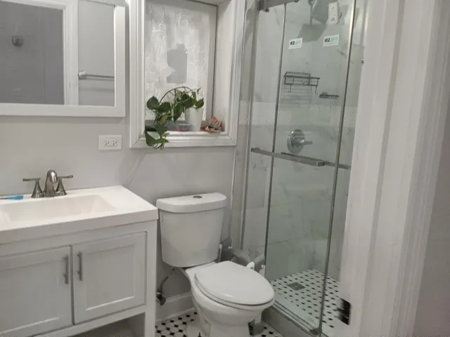 a bathroom with a sink toilet and shower