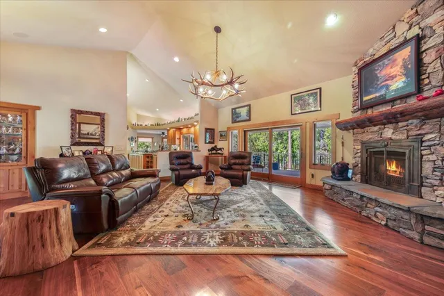 a kitchen with stainless steel appliances granite countertop a refrigerator a stove and a wooden floors