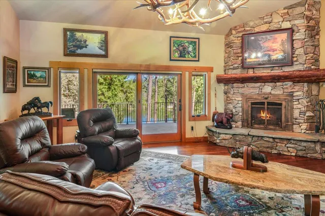 a view of a kitchen with kitchen island a large window a sink and a counter top space