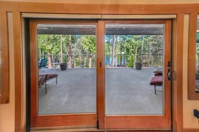 a large kitchen with stainless steel appliances granite countertop a large counter top a stove and a wooden floors