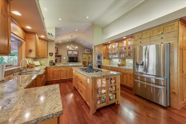 a view of a dining room with furniture wooden floor and chandelier