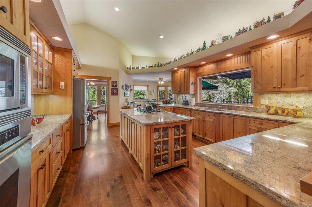 11790 Lowhills Road Nevada City, CA 95959 - Photo 18 of 68 a view of a kitchen with kitchen island a large window a sink and a counter top space