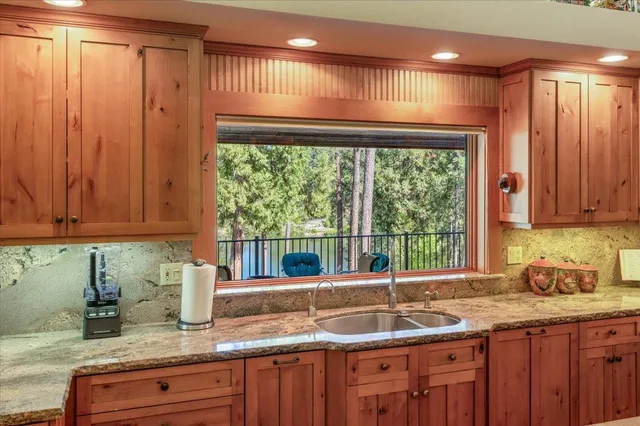 a bathroom with a granite countertop sink mirror vanity and bathtub
