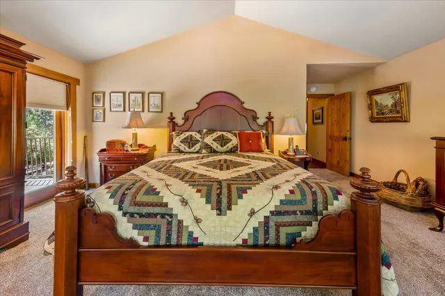 a bed sitting in a bedroom next to a large window